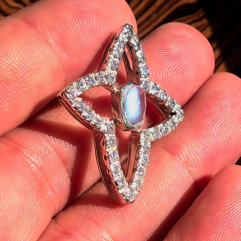 A beautiful sterling silver pendant necklace featuring a moonstone and cubic zirconias, showcasing its elegant design and craftsmanship.